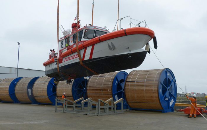 Fireboat being loaded on to vessel from the UK to George Town in the Cayman Islands in the Caribbean