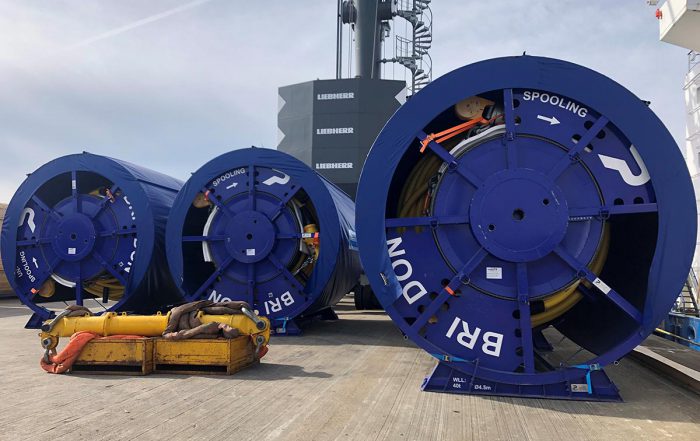 Large caable reels loaded on ship bound for the Caribbean